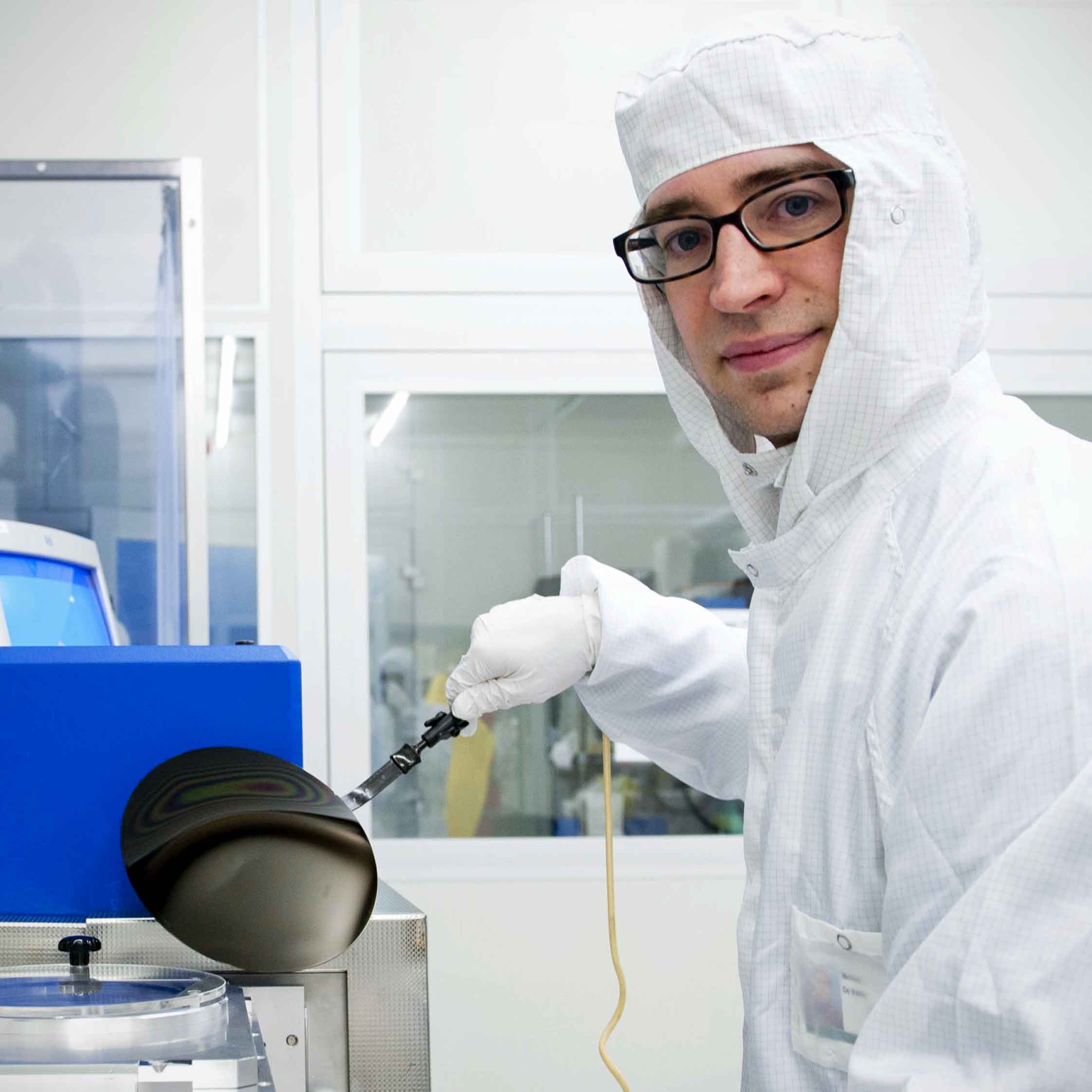 Dr De Volder holding a 200 mm silicon wafer covered with carbon nanoparticles